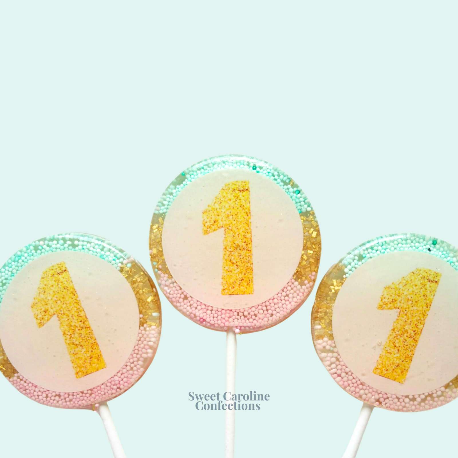 00365 EDIBLE WITH OMBRE AQUA, GOLD AND LIGHT PINK IN THE BACK - Sweet Caroline Confections | The Original Sparkle Lollipops
