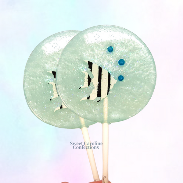 Bright angel fish sparkle lollipop with colorful edible accents and clear crystalline candy.
