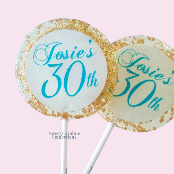 Personalized aqua and gold lollipops with custom names, featuring our signature sparkle formula for a high-end favor.