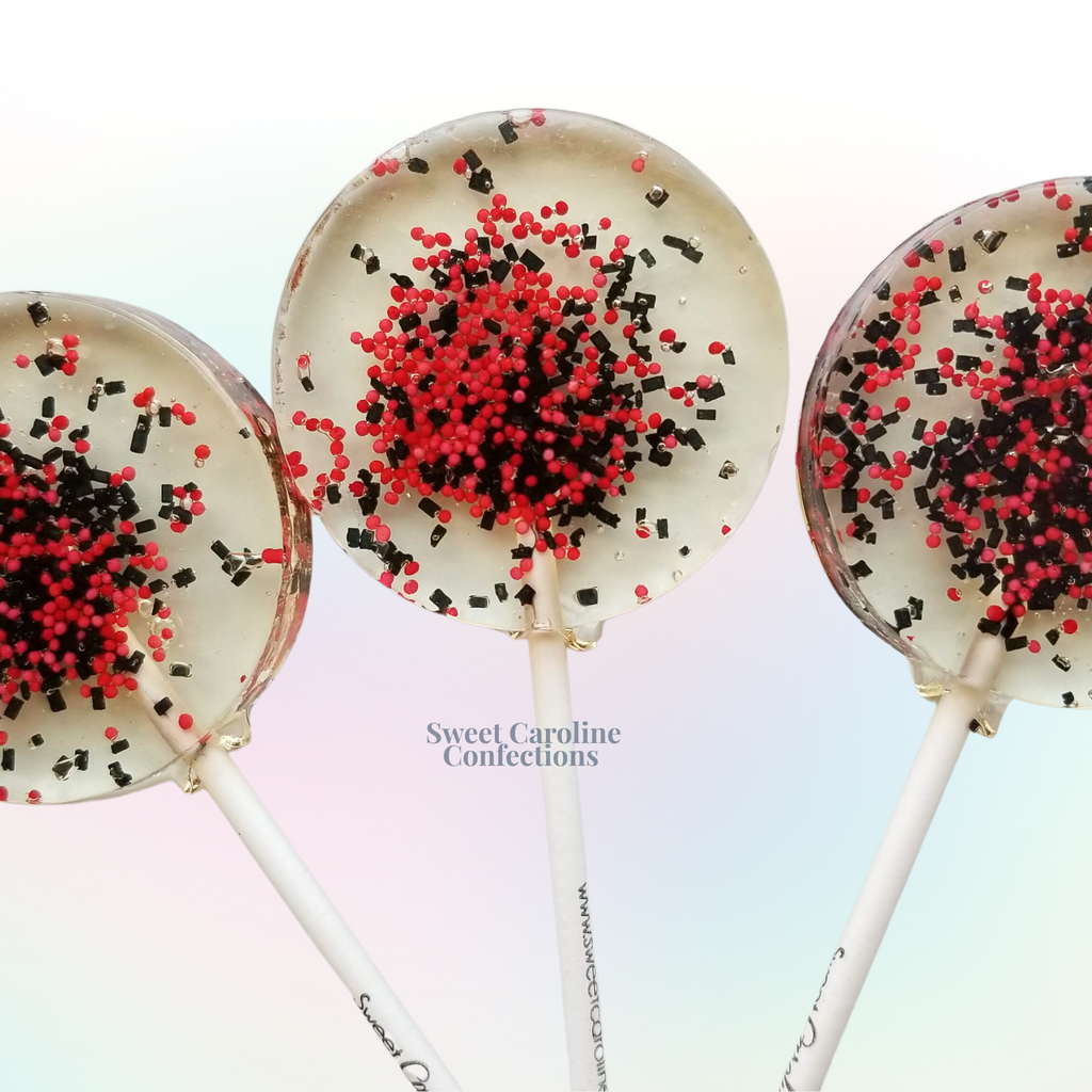 Black and red Halloween sparkle lollipops with festive nonpareils and sugar crystals from Sweet Caroline Confections.

