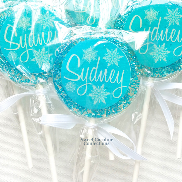 Sparkling blue and white lollipops with delicate snowflake designs, ideal for winter birthdays or "Onederland" themed parties.