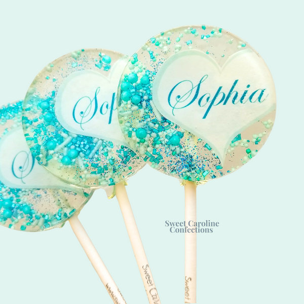 Custom blue sparkle lollipops featuring a modern gold half-heart design, handcrafted for birthday parties.