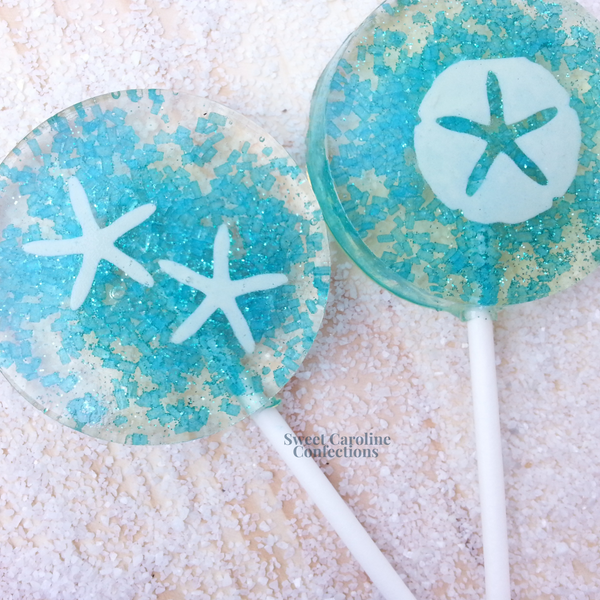 Vibrant blue sparkle lollipop featuring white starfish and sand dollar edible designs.
