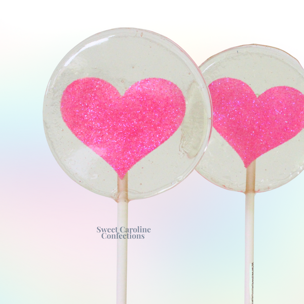 Bright pink heart shaped lollipops with signature sparkle