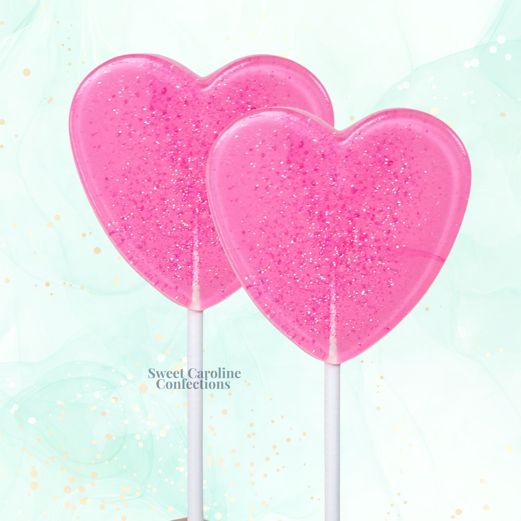 Bright pink sparkle lollipops with gold glitter and matching ribbon.
