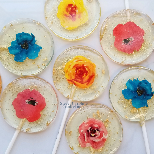 Vibrant Mexican-inspired flower lollipops with colorful edible petals and signature sparkle from Sweet Caroline Confections.