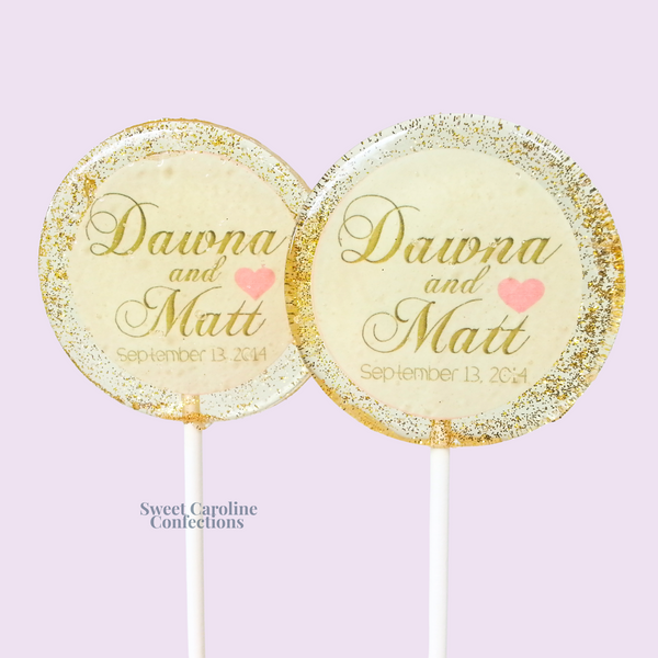 Custom wedding lollipops with names in gold on a white background with a pink heart.