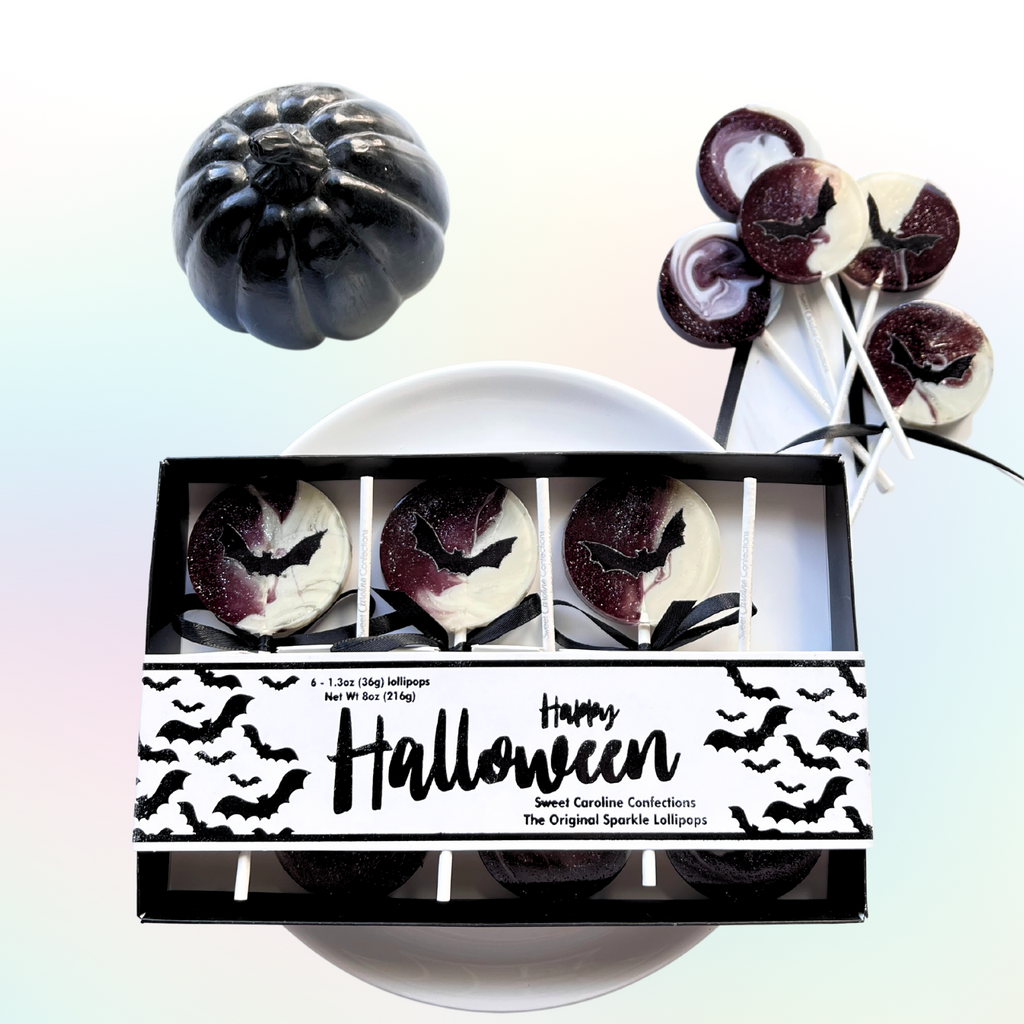 Happy Halloween gift box with six individually wrapped bat lollipops in a black and white swirl design from Sweet Caroline Confections.


