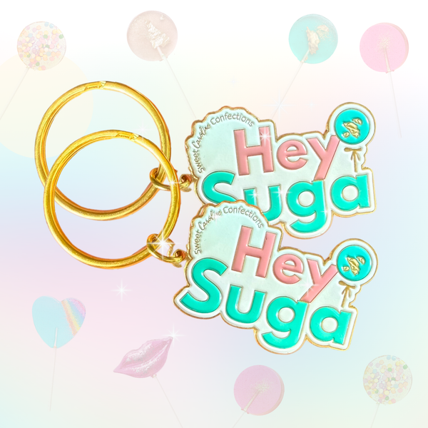 Hey Suga enamel keychain with pink letters and sparkle details.