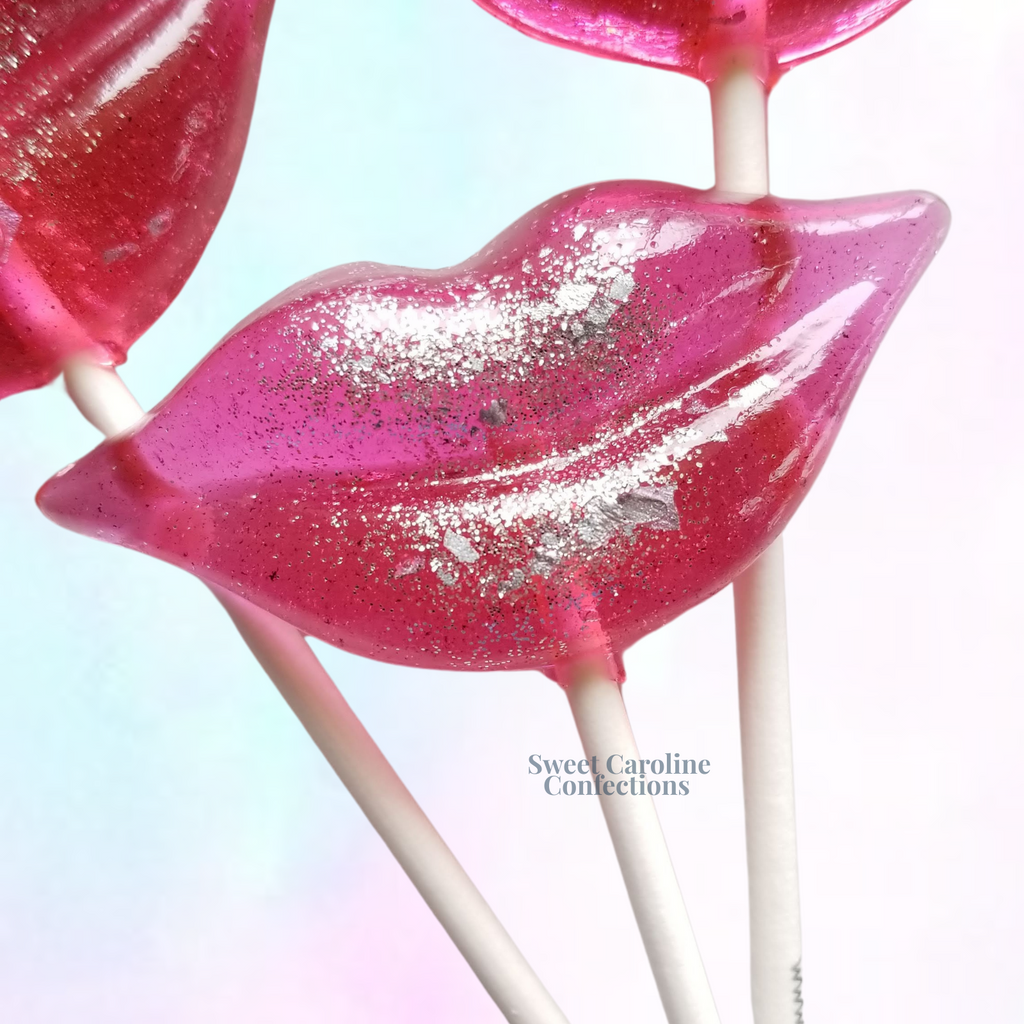 Hot pink lip shaped lollipops with silver sparkle.