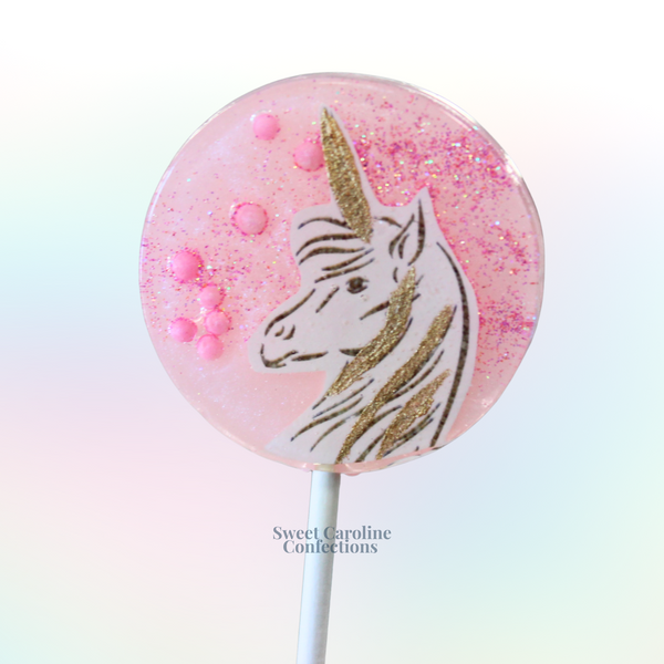 Light pink mystical pony lollipops with a bubblegum pink hard candy back and shimmering gold accents from Sweet Caroline Confections.

