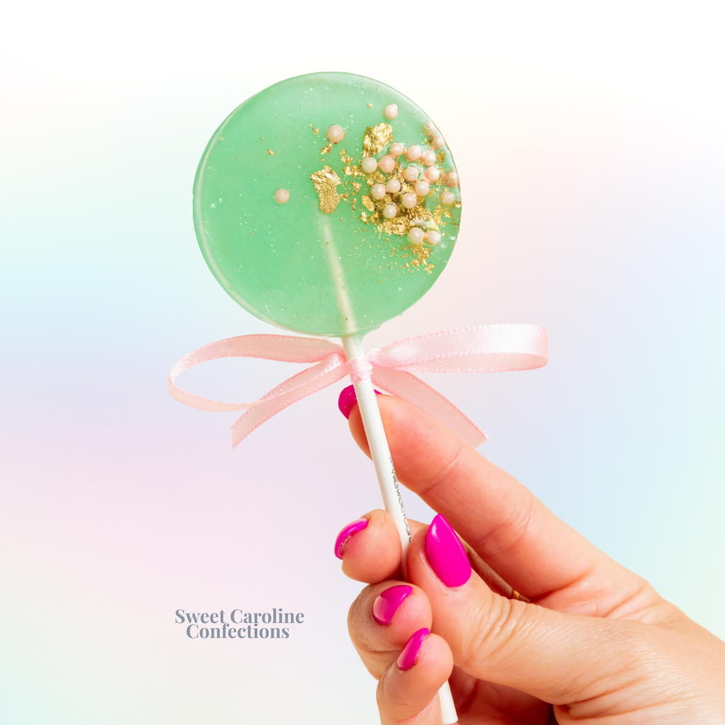 Mint green and light pink sparkle lollipops with gold glitter.