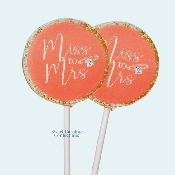 Ms. to Mrs. custom wedding lollipops with coral edible image and gold glitter.