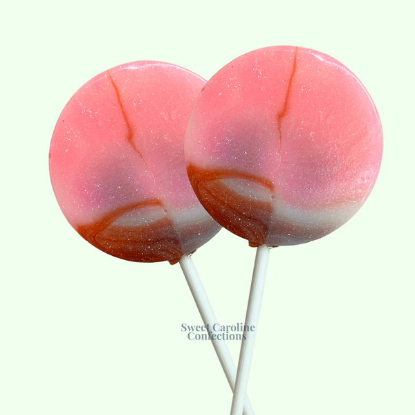 Multi-colored Neapolitan lollipops with beautiful layers of pink, white, and brown sparkle candy.