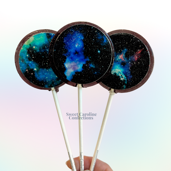 Galaxy-themed lollipops in blackberry flavor with cosmic sparkles and stars.