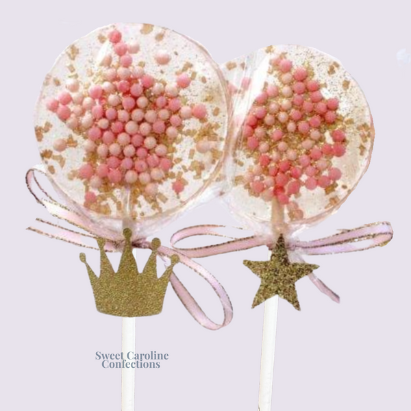 Elegant pink and gold lollipops featuring a princess crown tag and edible gold glitter for a royal birthday celebration.