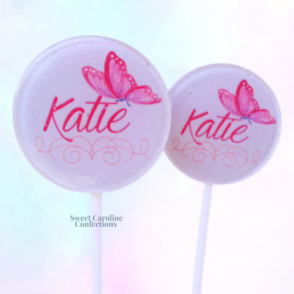 Whimsical pink and purple butterfly-shaped lollipops with holographic glitter, perfect for garden-themed or butterfly birthday parties.