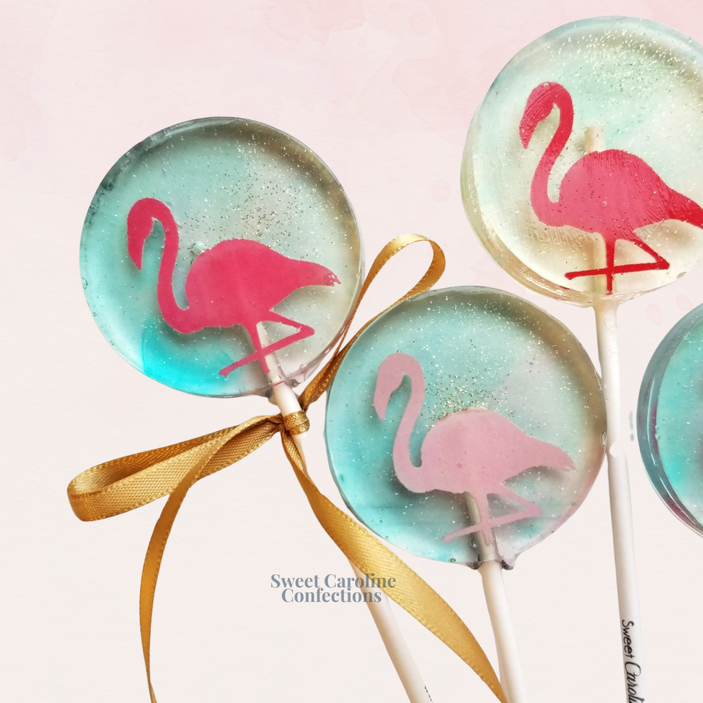 Top-down view of a set of flamingo-themed vegan lollipops.