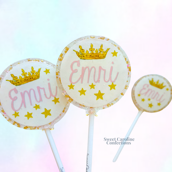 Elegant light pink and gold lollipops with a princess crown design and customizable name, handcrafted for a royal birthday celebration.