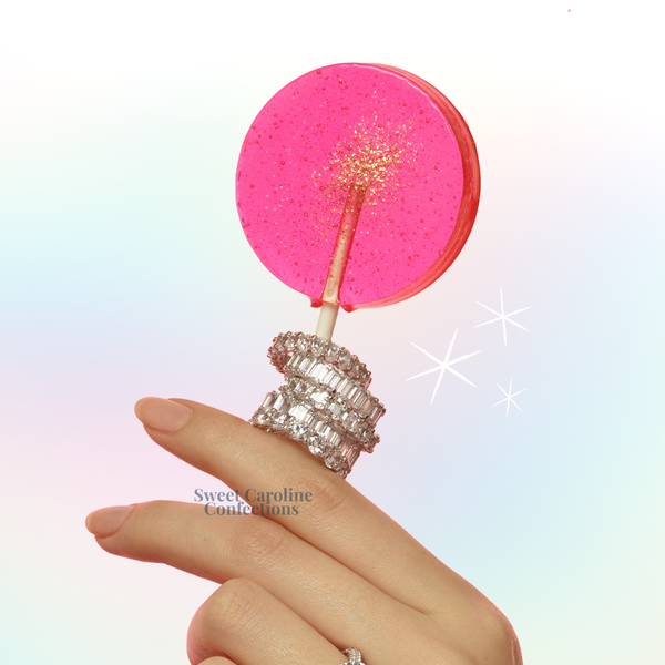 Pink and gold sparkle lollipops with watermelon flavor and edible glitter.