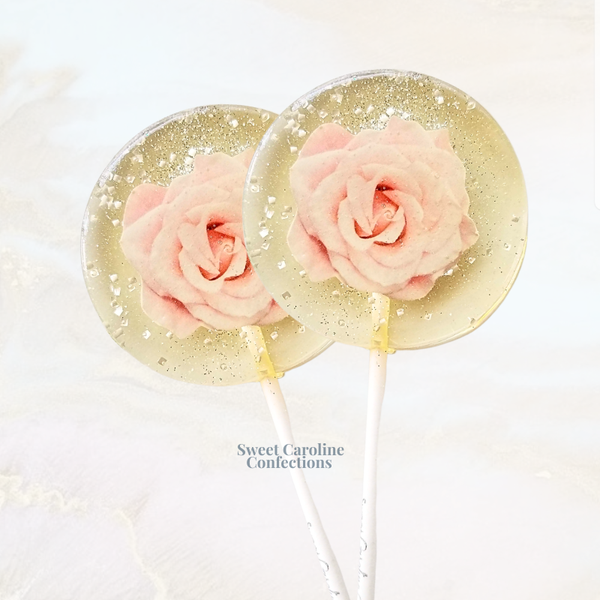 Romantic pink rose lollipops featuring elegant edible rose petals and signature sparkle accents.