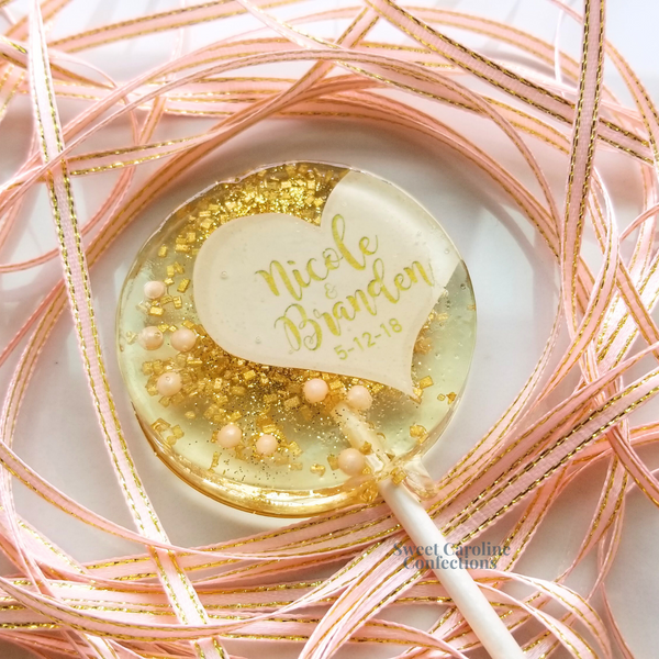 Elegant pink and gold sparkle lollipops with a half-heart design, ideal for sophisticated birthday party favors.