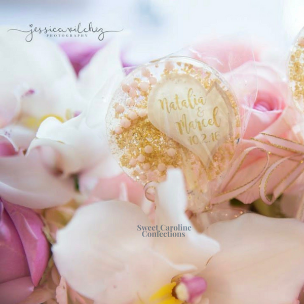 Elegant pink and gold sparkle lollipops with a half-heart design, ideal for sophisticated birthday party favors.