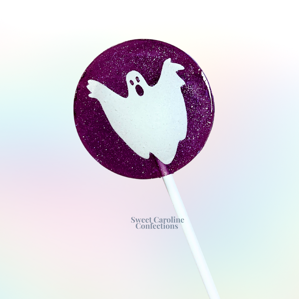 Purple ghost Halloween lollipops with intricate cut-out designs, cotton candy flavor, and a spooky seasonal finish from Sweet Caroline Confections