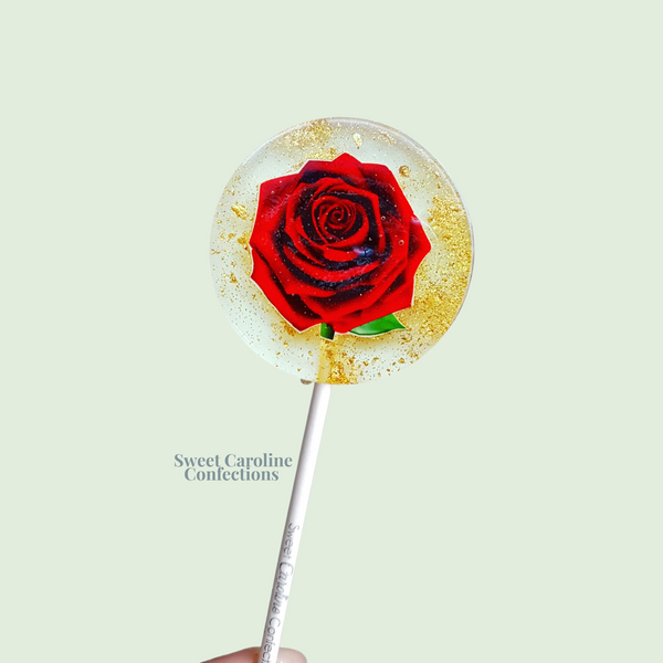 Classic red rose lollipops with deep red edible petals and gold glitter by Sweet Caroline Confections.