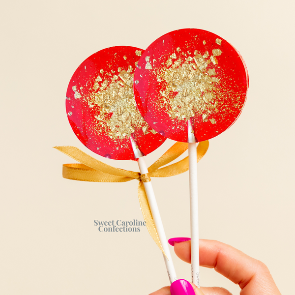 Red and gold sparkle lollipops with handcrafted edible glitter.