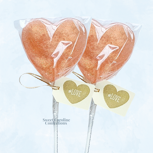 Rose gold sparkle lollipops with edible glitter, perfect for wedding favors.
