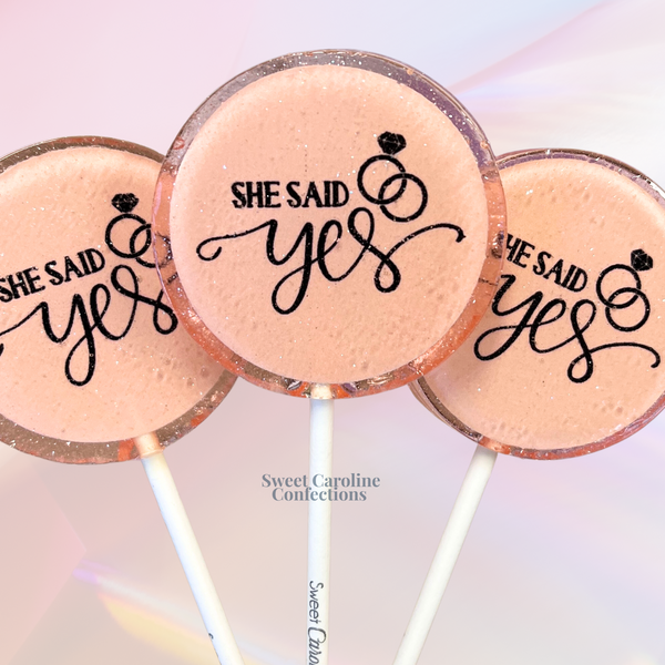 She Said Yes custom engagement lollipops with gold sparkles.