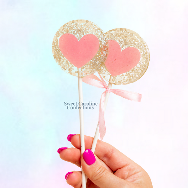 Silver and light pink heart shaped lollipops with edible glitter
