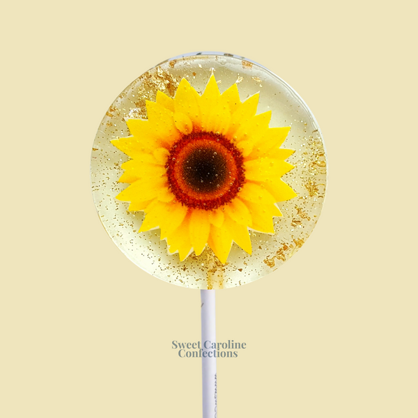 Bright sunflower lollipops featuring vibrant yellow edible petals and signature gold sparkle.