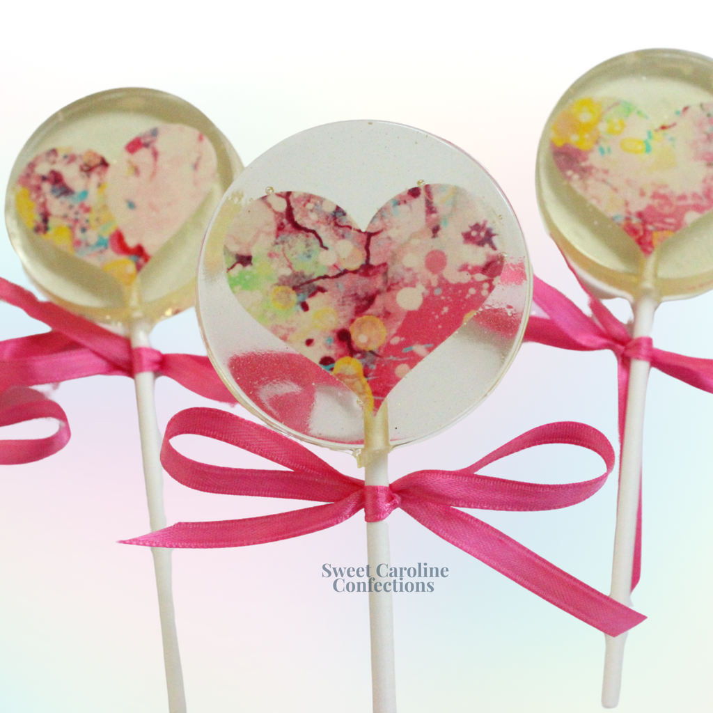 Heart shaped lollipops with a watercolor sparkle design.