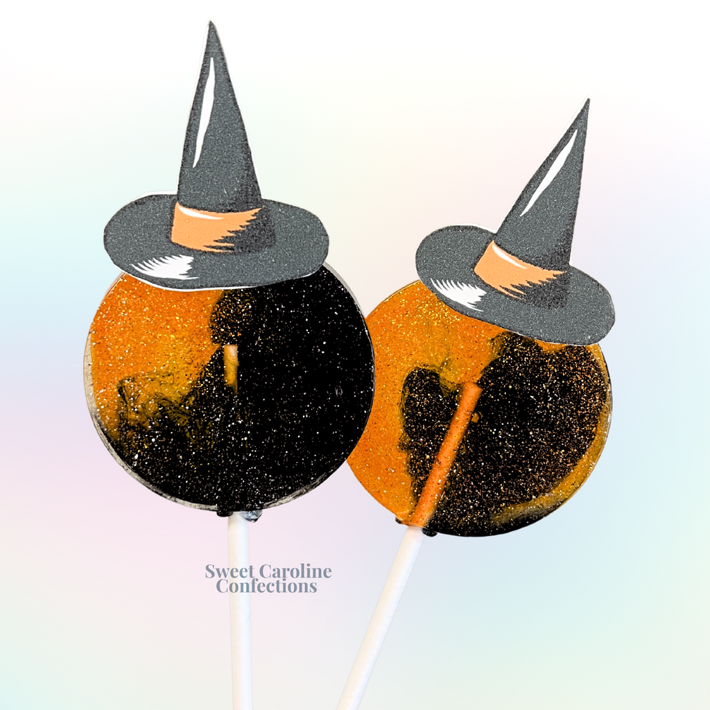 Black and orange witch hat Halloween lollipops with burnt orange edible glitter from Sweet Caroline Confections.

