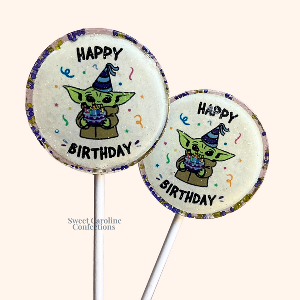 Star Wars-themed Yoda lollipops with "Happy Birthday" text and green sparkles, perfect for a galaxy-themed celebration.